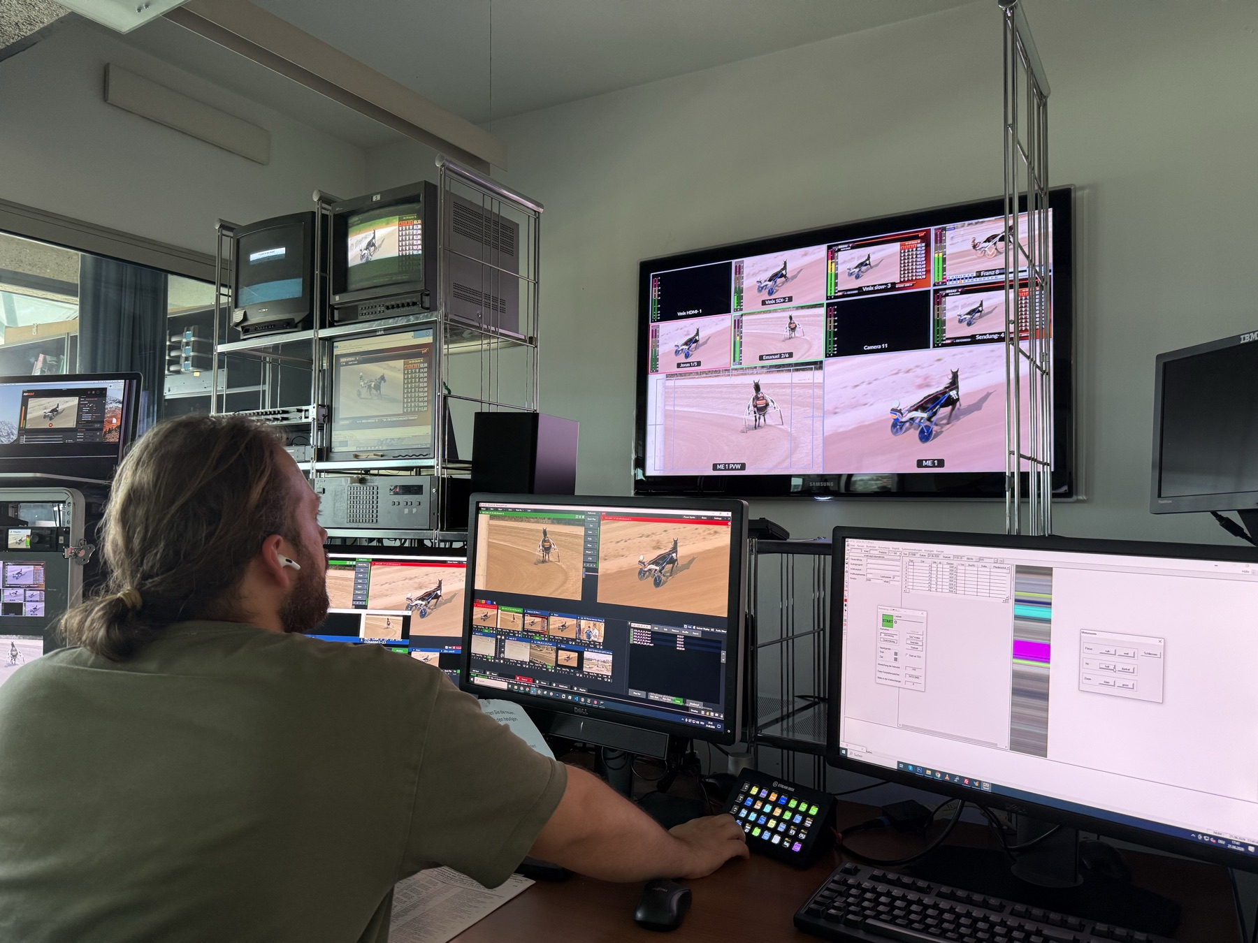 Race-day control room with operator monitors and live race video