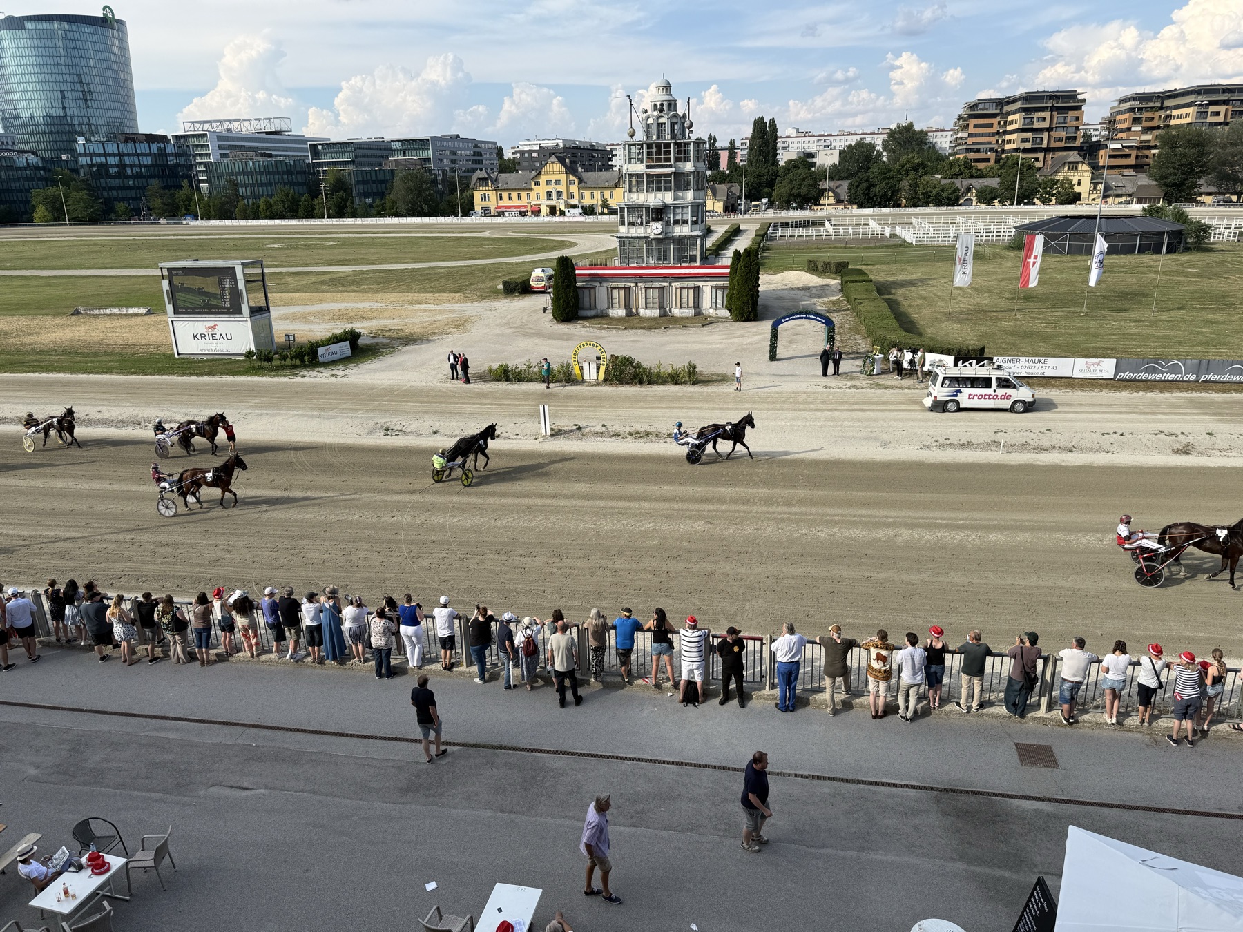 Krieau Derby race-day venue with horses, crowd, and timing tower